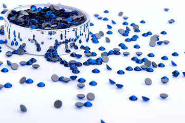 Precious sparkling rhinestones Capri blue colors on a white background.
