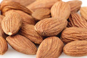 peeled almond seed on white background