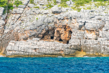 In the huge rocks there is the Blue Grotto with turquoise water. Montenegro.