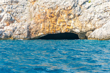 In the huge rocks there is the Blue Grotto with turquoise water. Montenegro.
