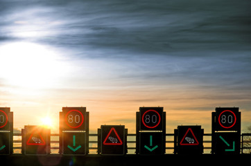 Verkehrsleitsystem Tempo 80 Schilderbrücke Baustellenwarnung im Gegenlicht