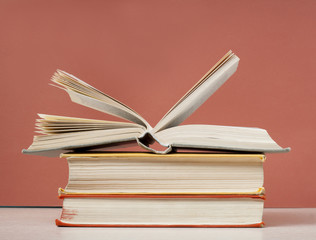 Open book, hardback books on wooden table. Education background. Back to school. Copy space for text.