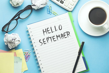 september text on notepad with stationary