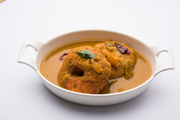 south indian food called vada sambar or sambar vada or wada dipped in sambar with coconut, green and red chutney and south indian style hot coffee, selective focus © StockImageFactory