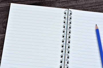 Notebook with pencil on desk