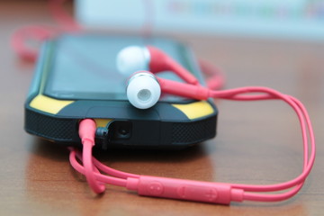 smartphone and headphones, side view, closeup special photo effect - soft focus, vignette