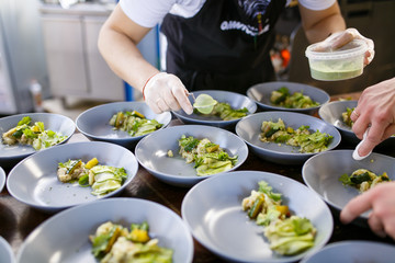 The chef decorates the dish before serving