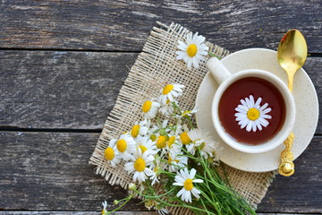 cup of herbal chamomile tea with camomile dry blossoms, dried camomile flowers. doctor treatment...