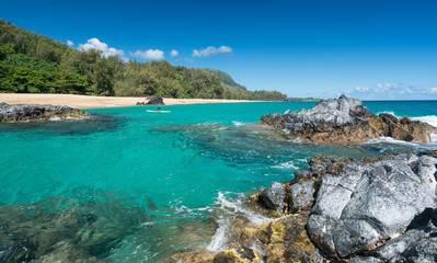 Lumahai Beach Kauai with rocks and surfer