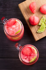 Watermelon, cucumber and lime cocktail in jars. View from above, top studio shot