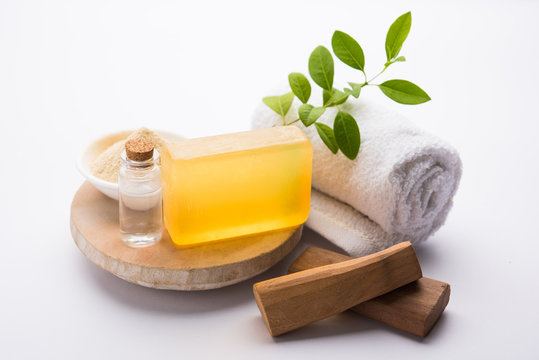 Ayurvedic handmade  Sandalwood both soap or chandan sabun with sandalwood sticks, ubtan or scrub or powder, oil and white towel, selective focus