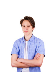 Teenager in blue shirt, keeping arms crossed, isolated on white background. Young man portrait