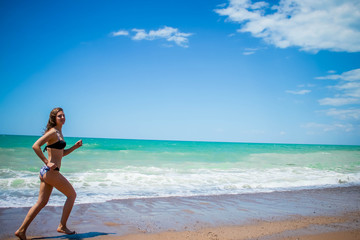 Fototapeta premium Girl on beach in swimsuit