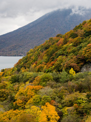 Fall colors in Nikko national park, Japan - view of Mount Nantai and lake Chuzenji
