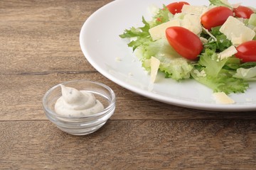 Fresh salad parmesan on a wooden background