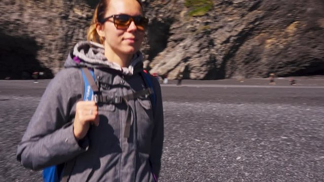 Woman exploring beautiful Reynisfjara beach near Vik, Icealnd