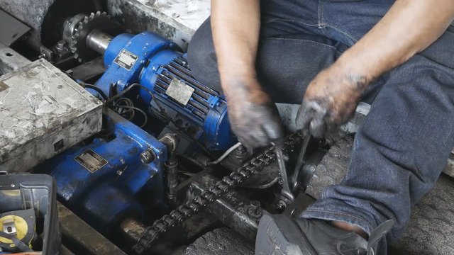 4k of Hand of repairman holding a wrench and tighten and during maintenance work of electric motor