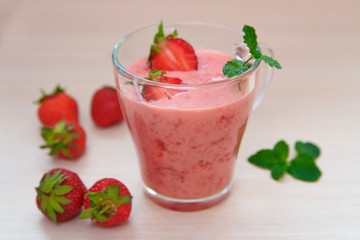 A glass of smoothies with strawberries and mint
