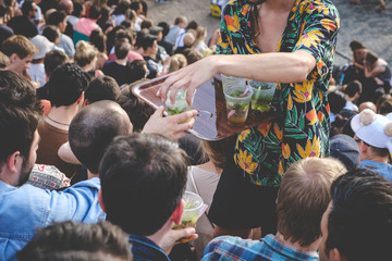  selling  drinks in crowded park