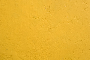 Close-up, full frame view a well-done light yellow wall texture background. Painted cement wall...