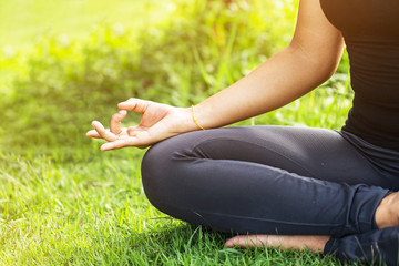 Yoga in the park, outdoor with effect light, health woman, Yoga woman. Concept of healthy lifestyle and relaxation.