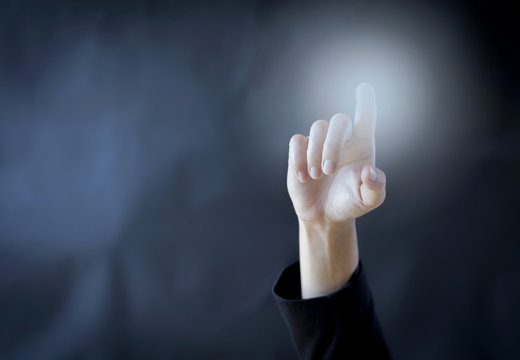 Business concept background of hand poiting over blurred dark background