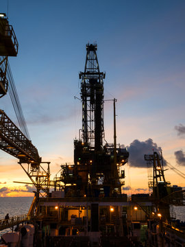 Derrick of Tender Assisted Drilling Oil Rig (Barge Oil Rig) on The Production Platform During Sunrise