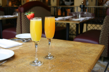Two mimosa cocktail glasses, lifestyle, horizontal