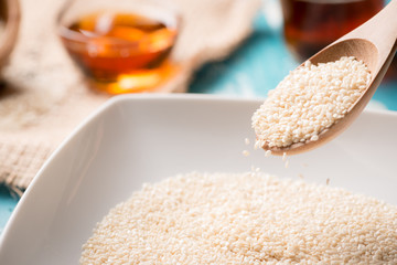 Sesame seeds and sesame oil on a old wooden table