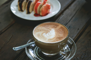 Cup of Latte coffee on wooden table
