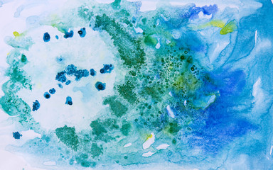 Watercolor background painting on white paper. Blue, green and golden abstract texture. Color smudges surface.