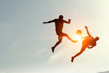 Obraz na płótnie Canvas Silhouettes of two soccer players