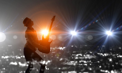 Fototapeta na wymiar Rock girl with guitar. Mixed media