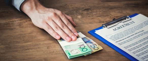 Businessman offering money while making an agreement