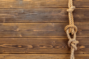 Fototapeta na wymiar Rope knot on wooden board
