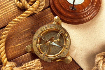 Compass and rope on wooden table. close up