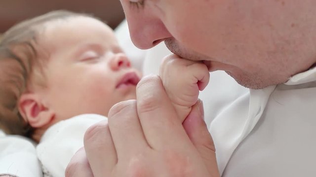 baby is sleeping on dad hands, Pope kisses hand of baby
