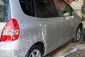 washing a car with soapy water