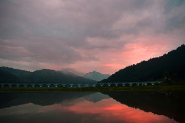 beautiful sunset with lake and Carpathian mountain landscape, Romania