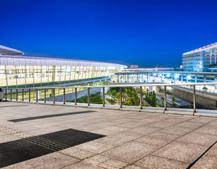 empty brick platform with Shanghai skyline at night in background.