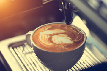 how to make latte art by barista focus in milk and coffee in vintage color