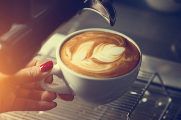 how to make latte art by barista focus in milk and coffee in vintage color