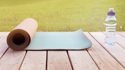 a yoga mat and a bottle of water on a terrace