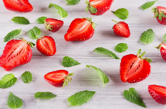 Colorful summer background of strawberry and mint leaf on white background.