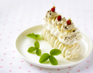 meringue cake with fresh berries on white background