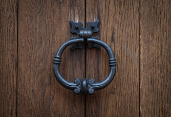 The old rusty ring on a wooden door