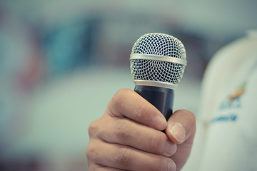 blurred of businessman speech, talking with microphone, gray scale tone