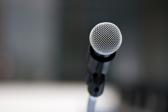 Close up of classic microphone on note stand in bokeh background