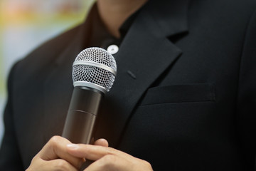 blurred of businessman speech, talking with microphone keynote and remote to presentation