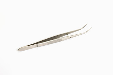 Tweezers tool isolated on white background. Closeup shot. top view